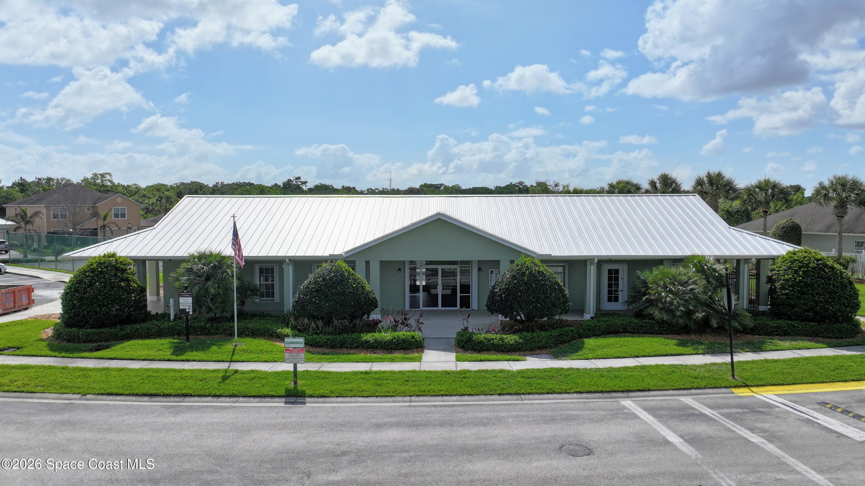 183 Stony Point Drive Sebastian, FL 32958 - Photo 24 of 27 a front view of a house with a yard and potted plants