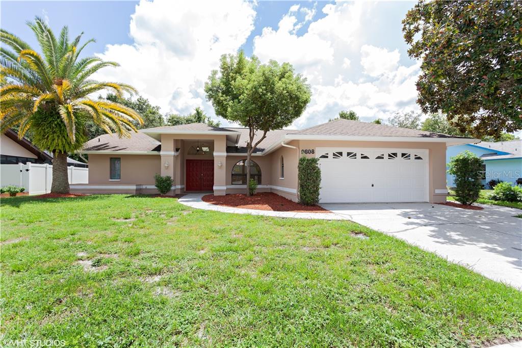 9608 Vía Segovia New Port Richey, FL 34655 - Photo 1 of 1 a front view of a house with a yard and garage