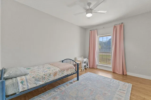 a bedroom with a bed and a large window