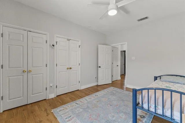 a view of a bedroom with wooden floor