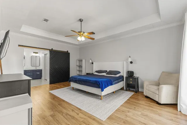 a spacious bedroom with a bed and a couch