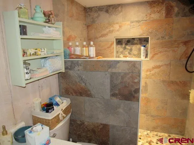 a bathroom with a sink mirror and toilet