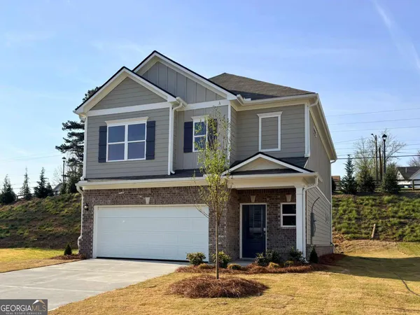 a front view of a house with a yard and garage