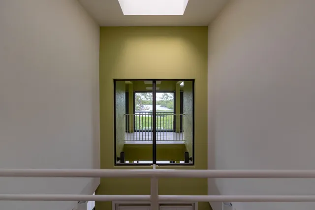 a living room with furniture and a floor to ceiling window