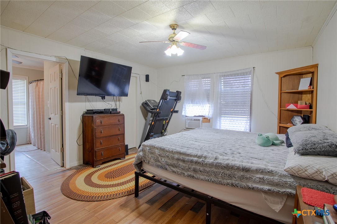 705 West Ash Street Edna, TX 77957 - Photo 11 of 19 a bedroom with a bed and a flat screen tv