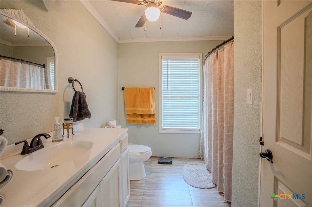 705 West Ash Street Edna, TX 77957 - Photo 12 of 19 a bathroom with a sink toilet and shower