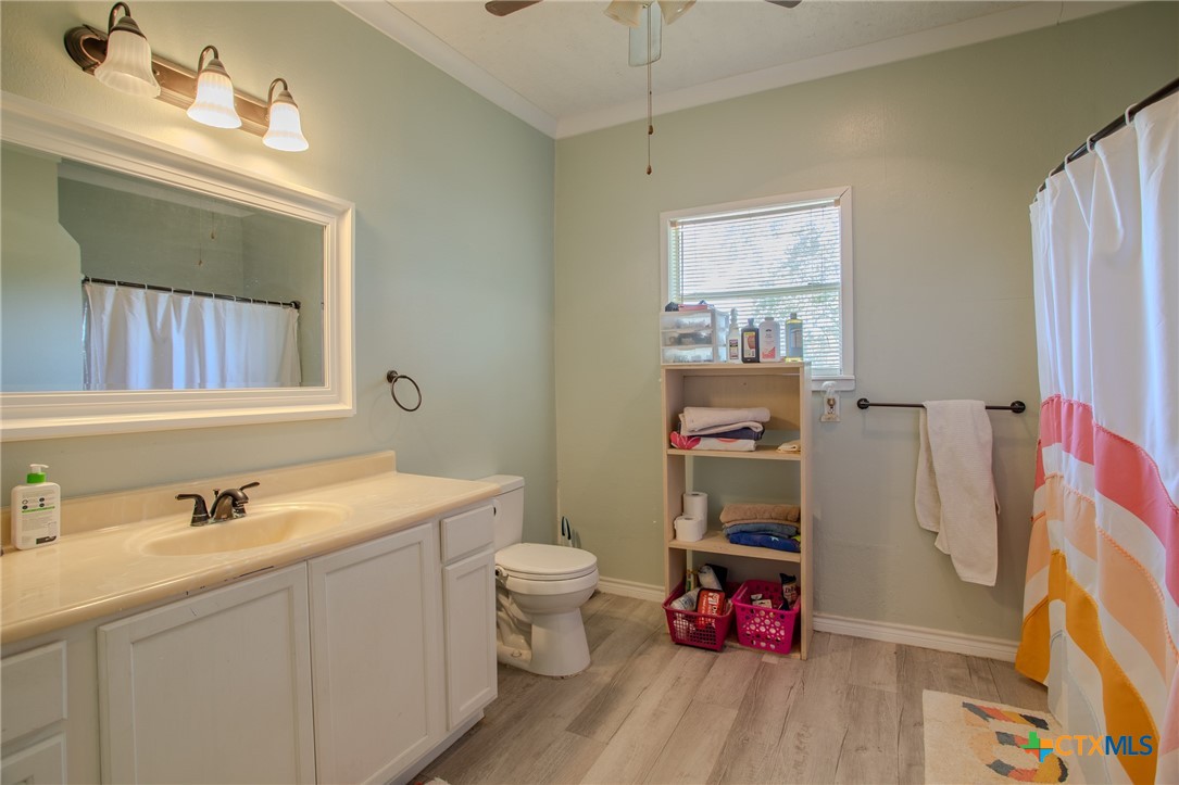705 West Ash Street Edna, TX 77957 - Photo 13 of 19 a bathroom with a sink mirror and toilet