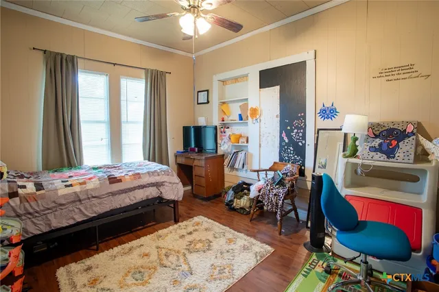 a bedroom with bed and a window