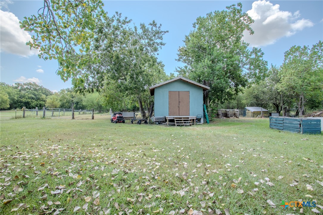 705 West Ash Street Edna, TX 77957 - Photo 18 of 19 a view of a house with backyard and tree