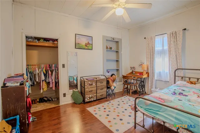 a bedroom with furniture a rug and a chandelier
