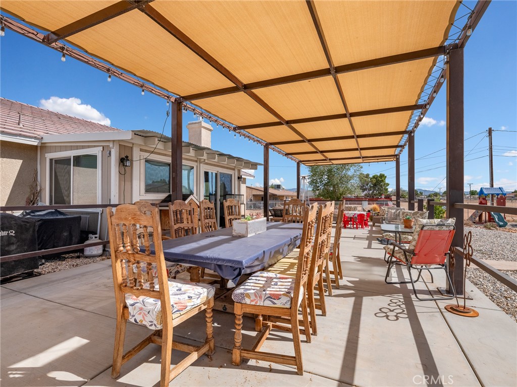 15620 Erie Road Apple Valley, CA 92307 - Photo 35 of 53 a patio with glass top table and chairs