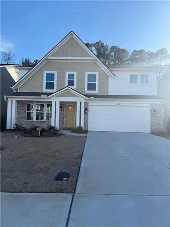 a front view of a house with parking space