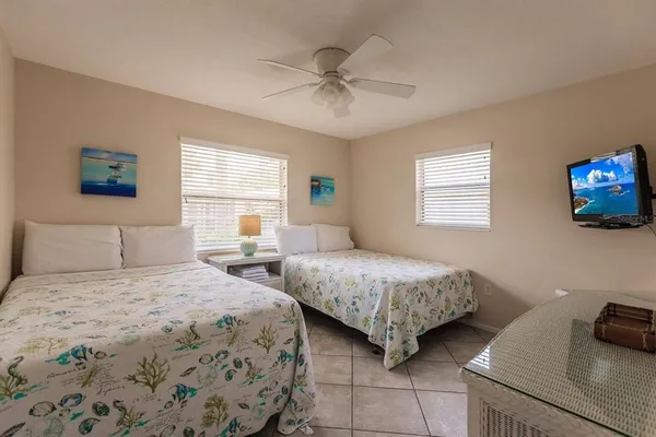a bedroom with two beds and a window