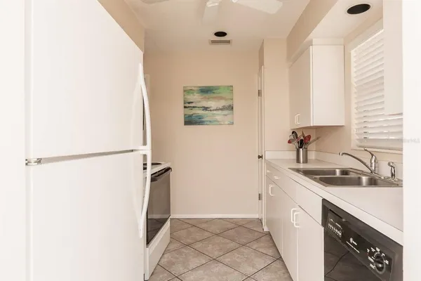 a kitchen with a sink and a refrigerator