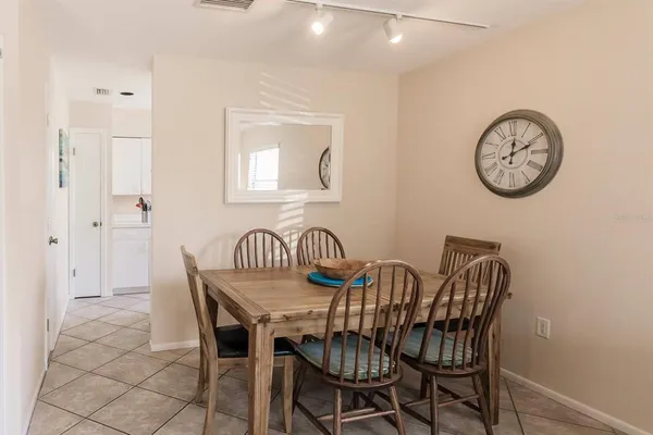 a view of a dining area with furniture and a mirror