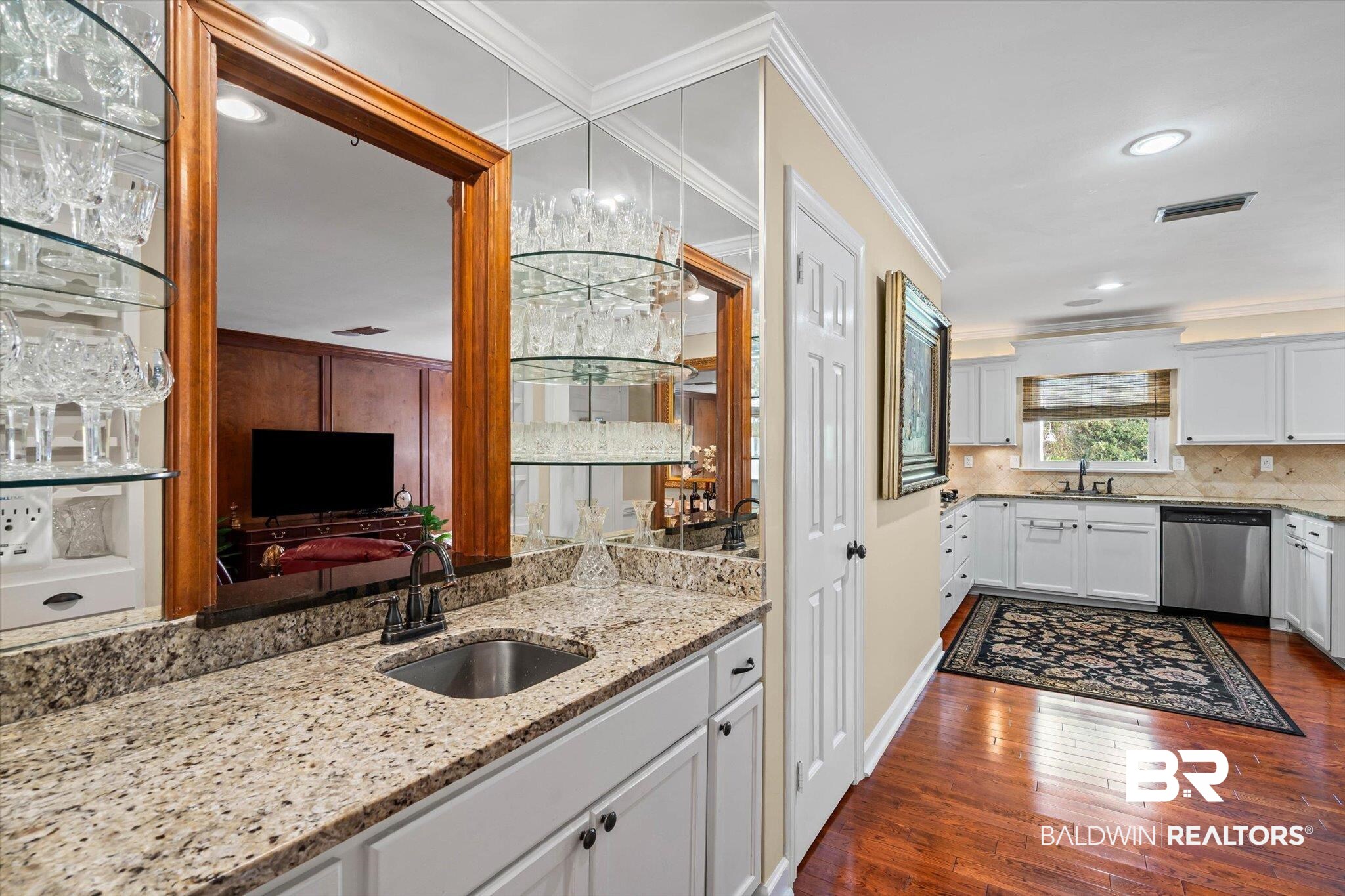 1517 Ridgeland Road East Mobile, AL 36695 - Photo 10 of 39 Kitchen with wet bar area, light stone countertops, white cabinets, ornamental molding, dark wood-style flooring, and recessed lighting