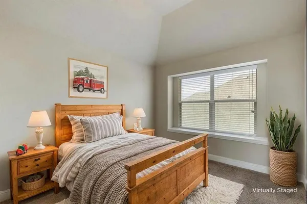a bedroom with bed and window