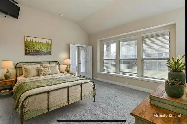 a bedroom with a bed and windows