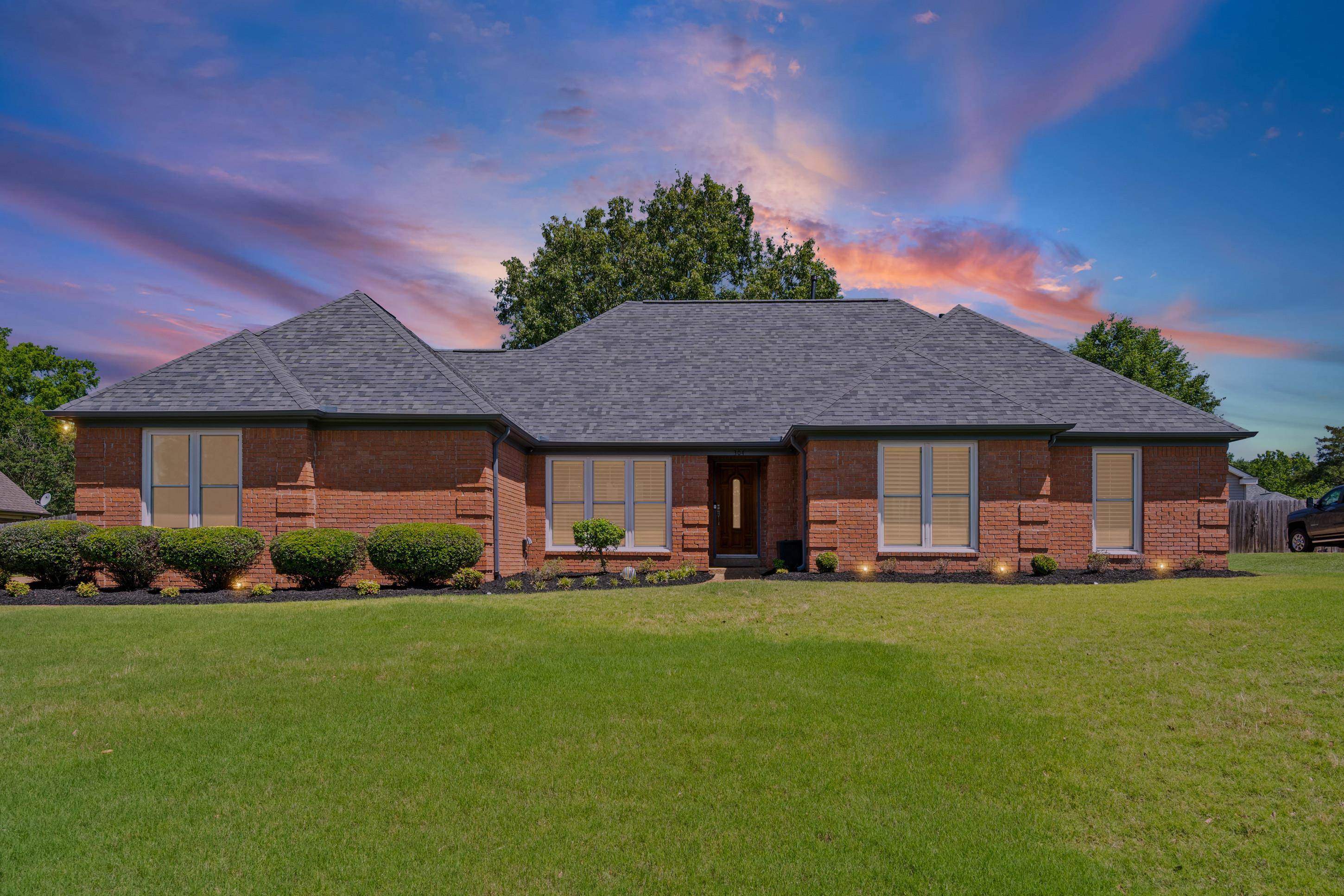 304 Spring Mill Road Collierville, TN 38017 - Photo 1 of 32 Traditional brick exterior with a gray shingle roof and a manicured lawn