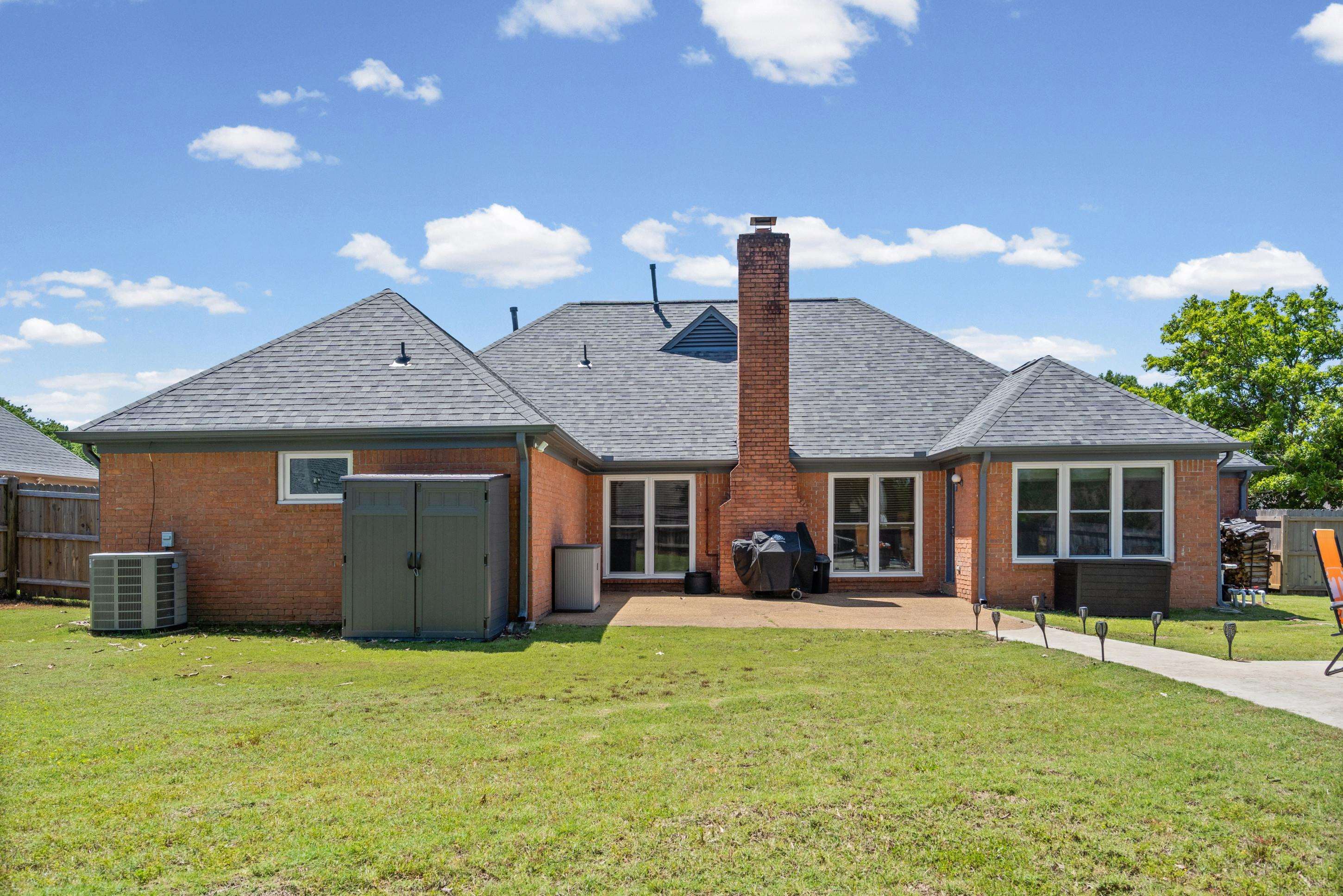 304 Spring Mill Road Collierville, TN 38017 - Photo 27 of 32 Rear exterior of a brick residence featuring a multi-pitch shingle roof