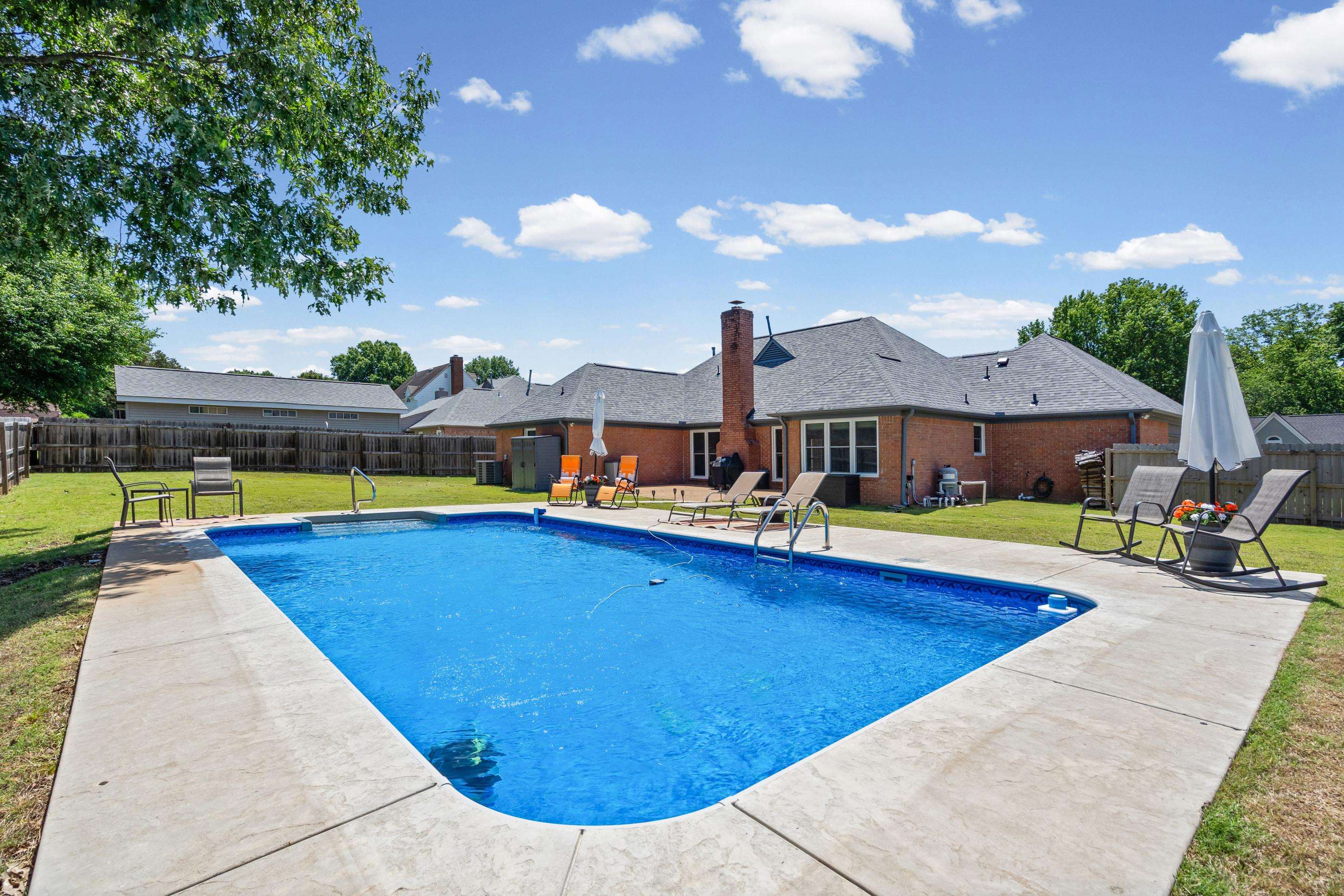 304 Spring Mill Road Collierville, TN 38017 - Photo 28 of 32 Inviting inground swimming pool with a surrounding concrete patio