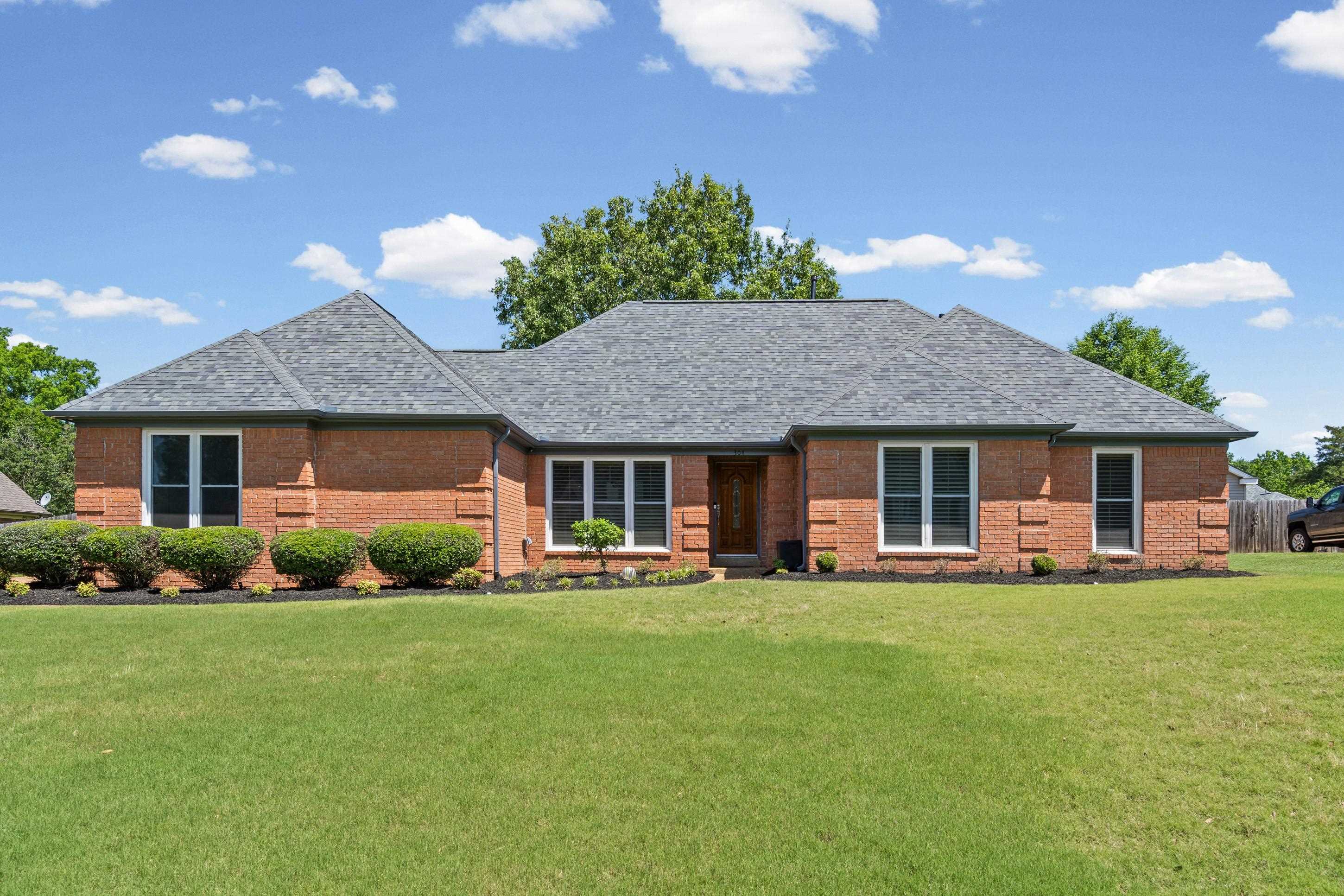 304 Spring Mill Road Collierville, TN 38017 - Photo 3 of 32 Brick exterior residence featuring a gray shingle roof and white-framed windows
