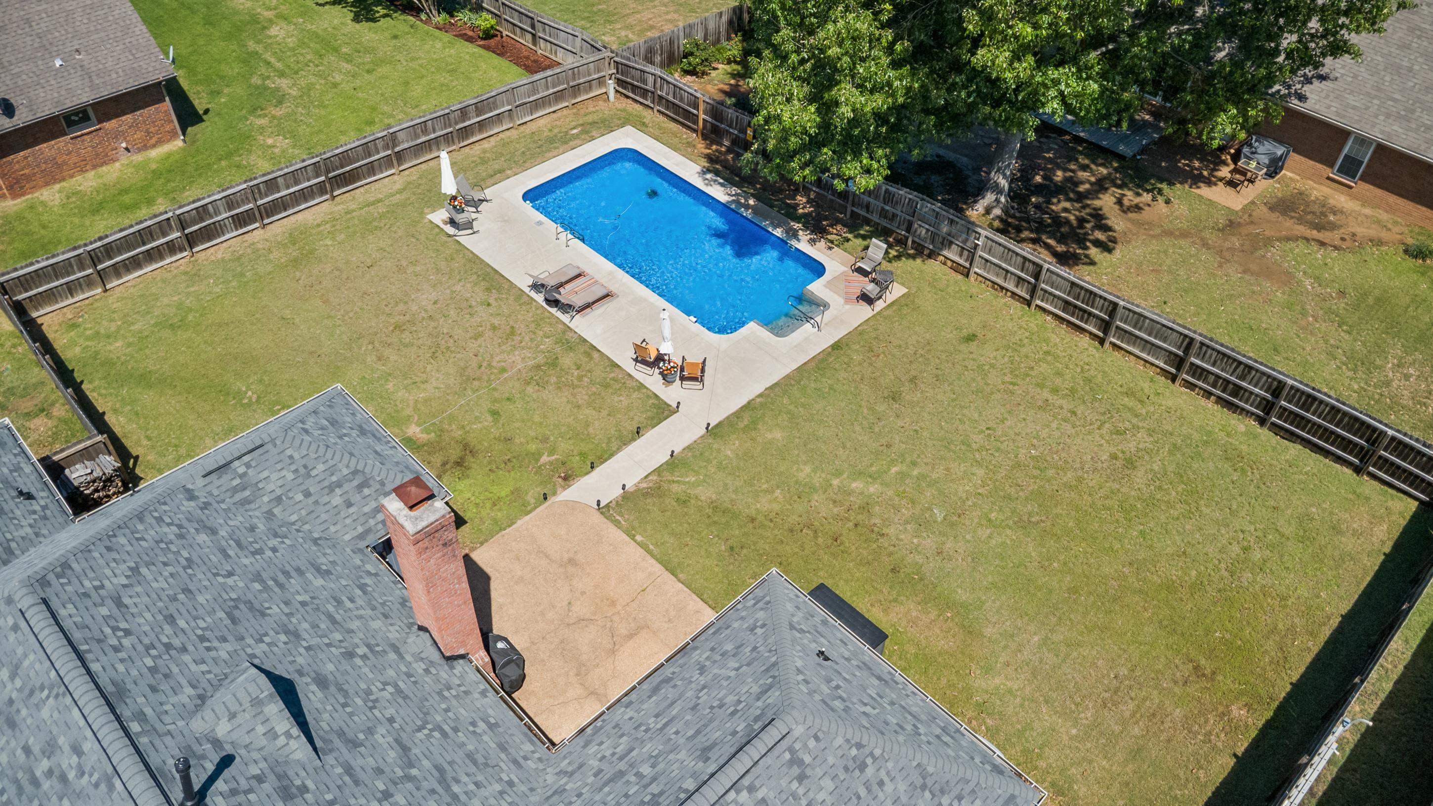 304 Spring Mill Road Collierville, TN 38017 - Photo 31 of 32 Expansive backyard featuring a rectangular swimming pool with surrounding concrete patio