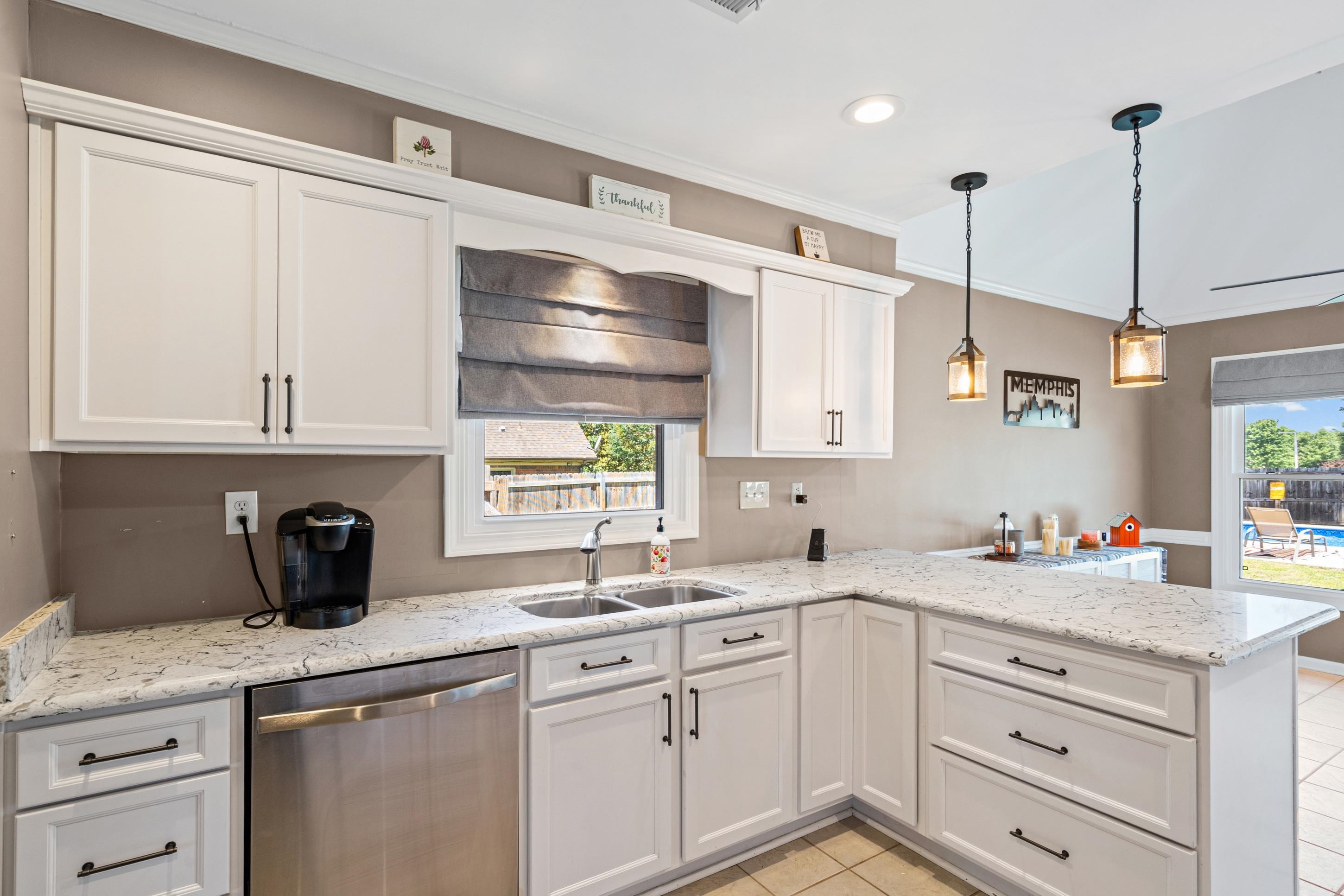 304 Spring Mill Road Collierville, TN 38017 - Photo 8 of 32 Kitchen featuring white shaker cabinetry, speckled countertops, stainless steel appliances, and a double basin sink