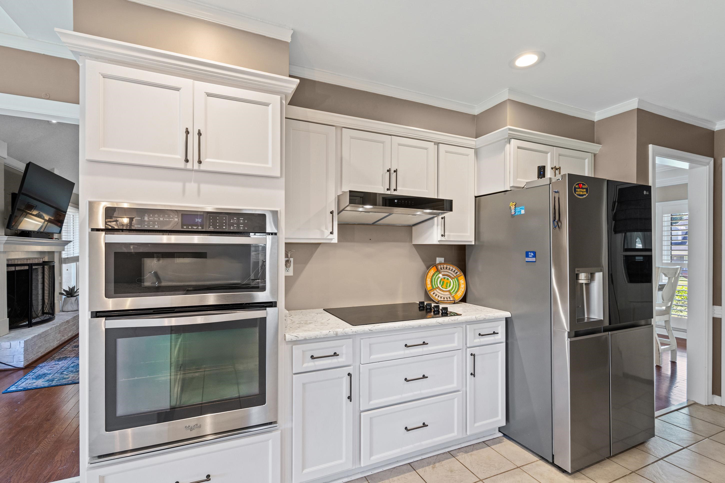 304 Spring Mill Road Collierville, TN 38017 - Photo 9 of 32 Kitchen featuring white shaker cabinetry, stainless steel double wall oven, stainless steel built-in microwave, and a black cooktop