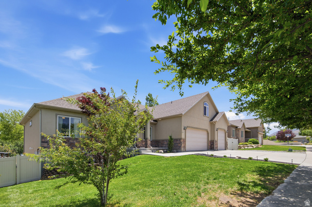 1252 Skyline Road Saratoga Springs, UT 84045 - Photo 4 of 51 Contemporary stucco exterior with stone accents and a two-car garage