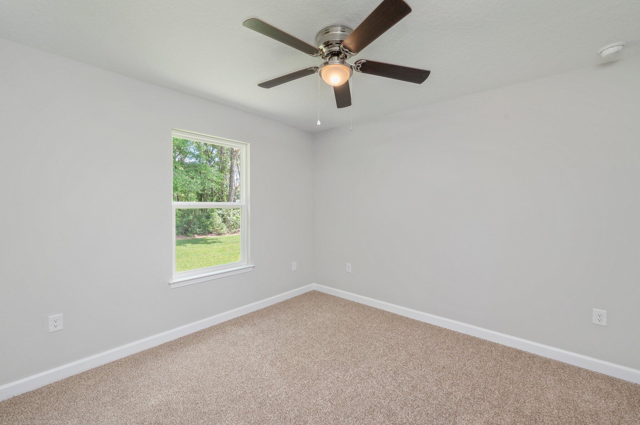 3158 Chestnut Street Crestview, FL 32539 - Photo 22 of 26 an empty room with a window and a fan