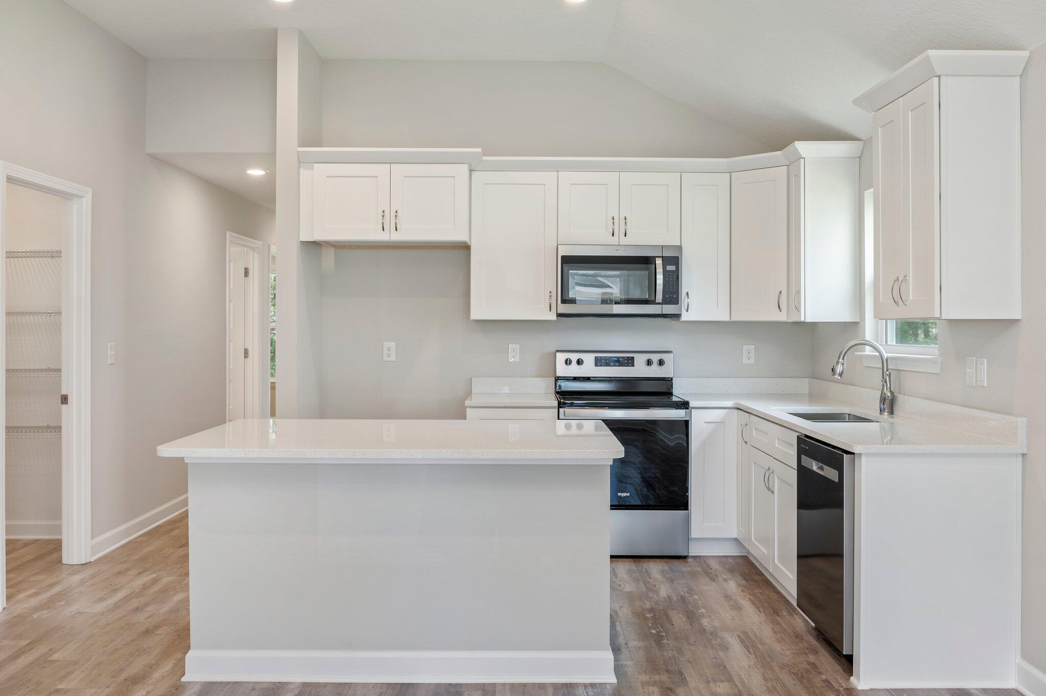 3158 Chestnut Street Crestview, FL 32539 - Photo 7 of 26 a kitchen with stainless steel appliances a stove a sink and a refrigerator