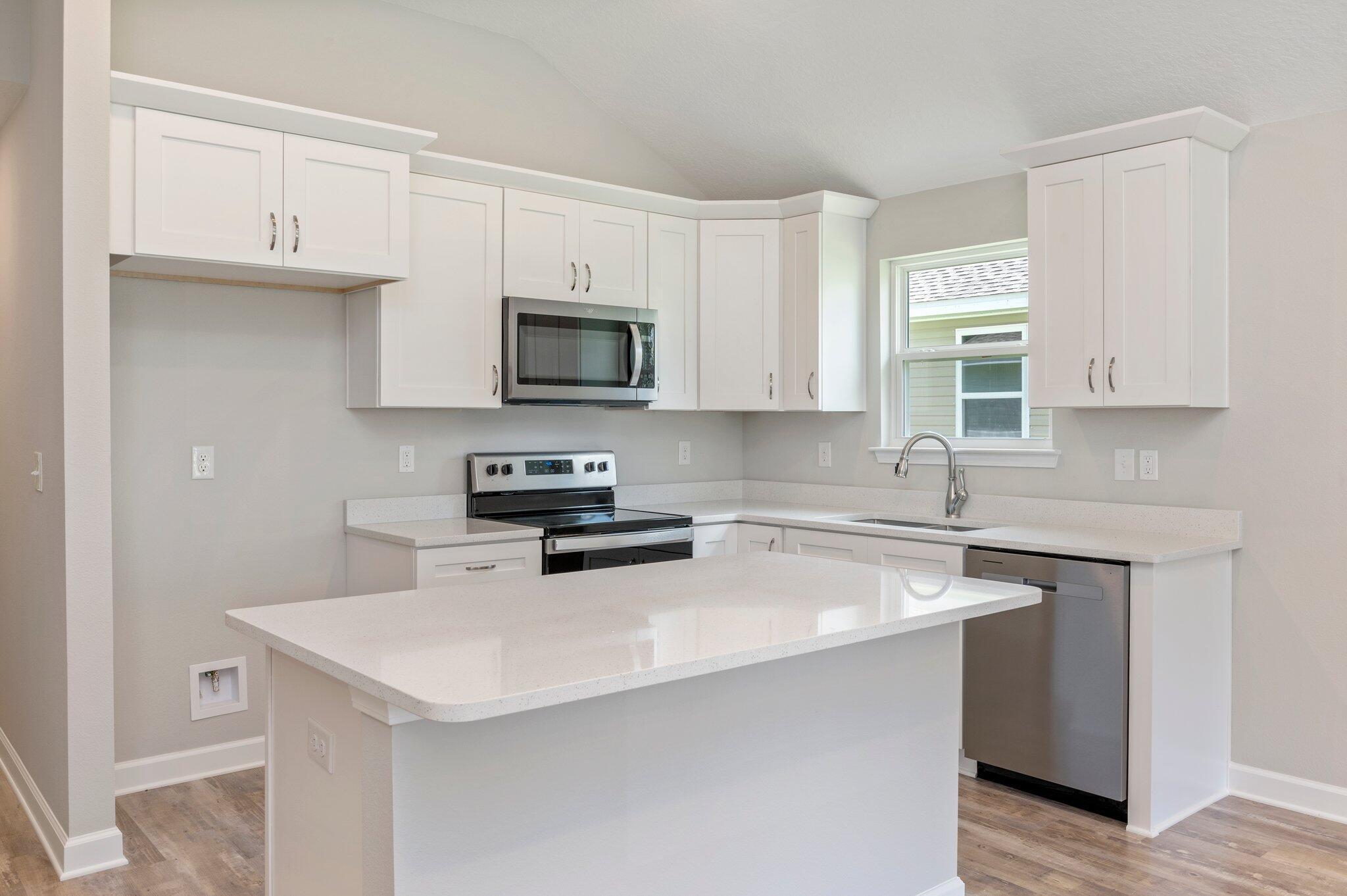 3158 Chestnut Street Crestview, FL 32539 - Photo 8 of 26 a kitchen with cabinets appliances a sink and a counter top space