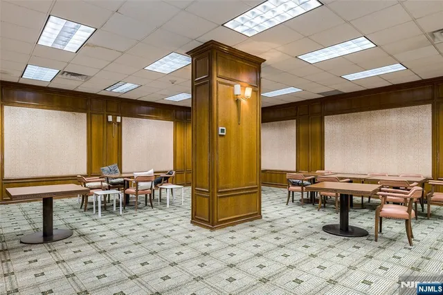 a living room with a table and chairs