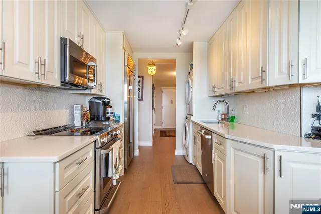a kitchen with stainless steel appliances granite countertop a stove and a sink