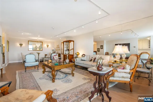 a living room with lots of furniture and a view of kitchen