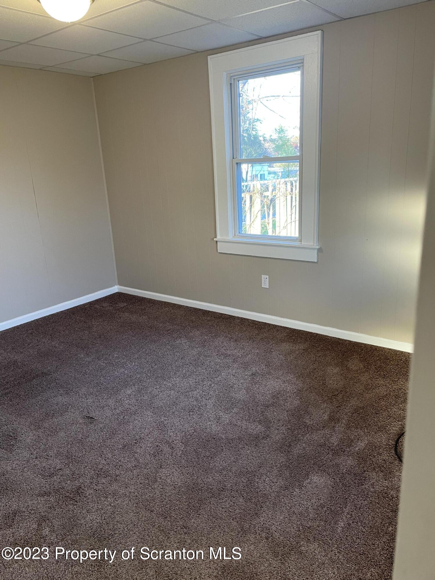 507 Church Street Jessup, PA 18434 - Photo 2 of 6 an empty room with windows
