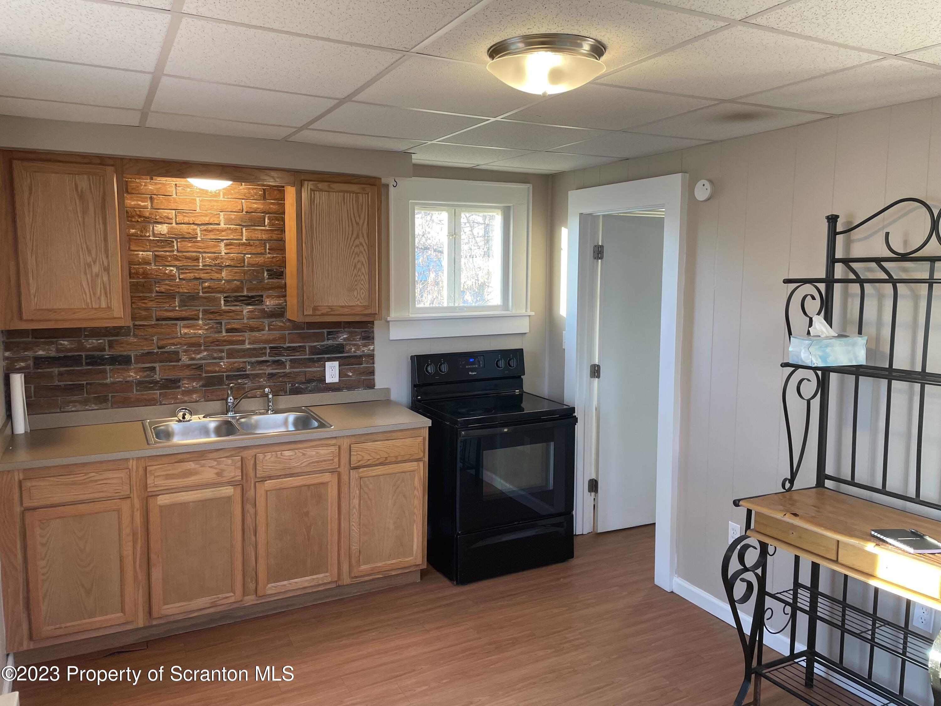 507 Church Street Jessup, PA 18434 - Photo 3 of 6 a kitchen with stainless steel appliances granite countertop a stove a sink and a microwave