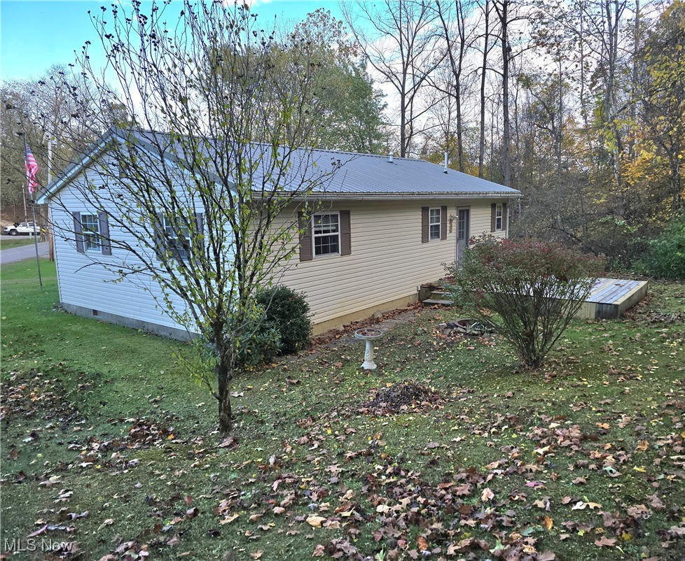 8019 Kroft Road Mount Perry, OH 43760 - Photo 9 of 41 View of side of home featuring a lawn, a metal roof, and crawl space