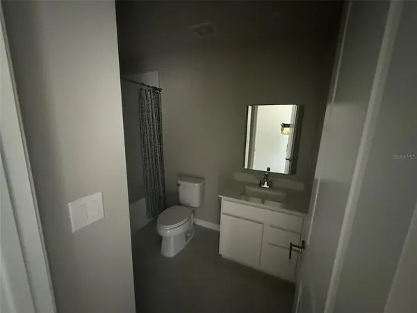 a bathroom with a sink toilet and mirror