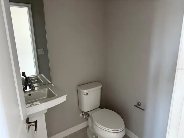 a white toilet sitting next to a bathroom sink
