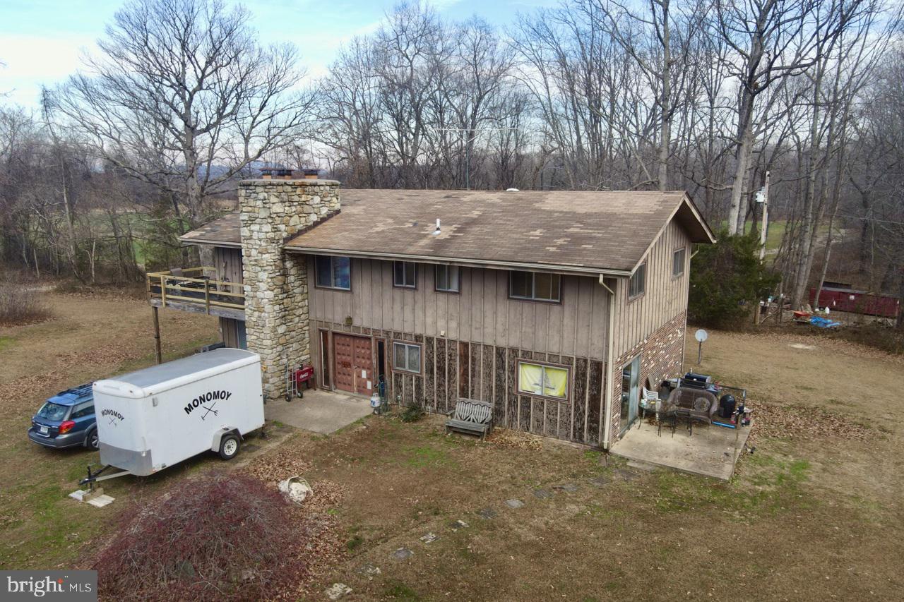 7389 Leeds Manor Road Marshall, VA 20115 - Photo 24 of 33 a view of a patio with table and chairs with wooden fence and large trees