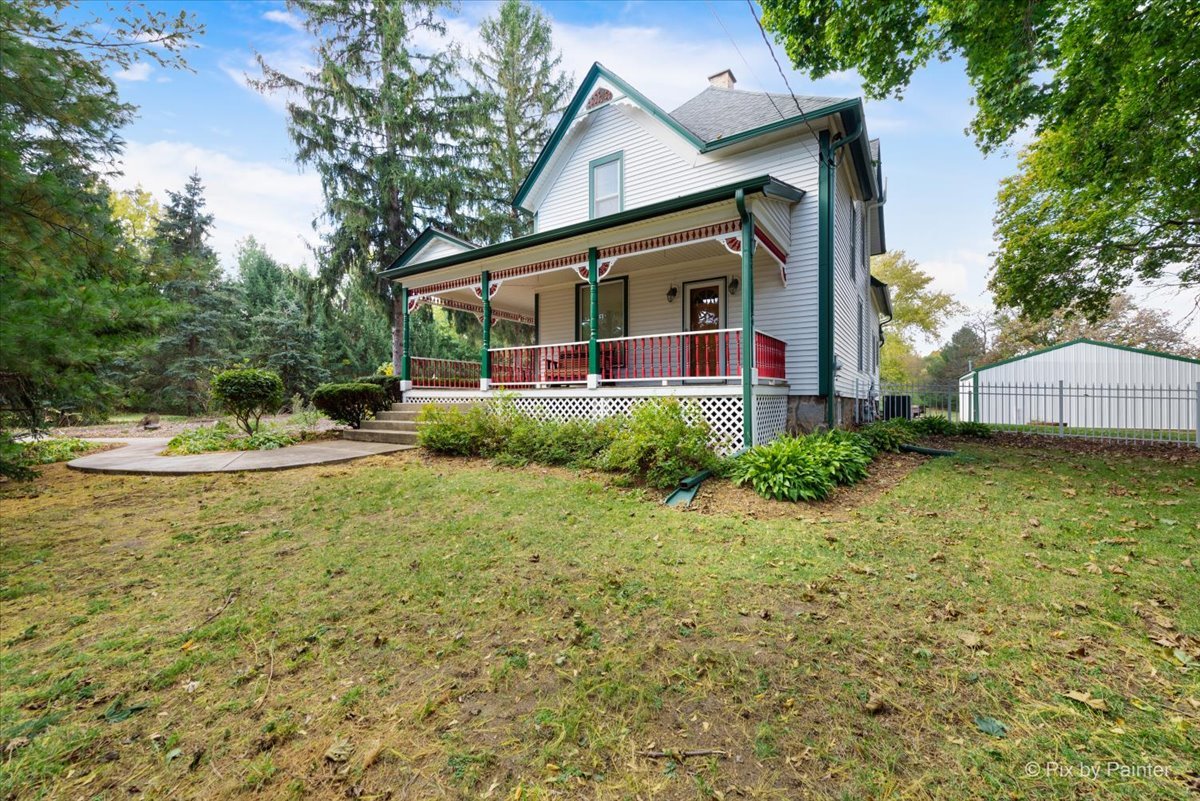 3019 North Ringwood Road McHenry, IL 60050 - Photo 2 of 2 a front view of a house with a yard