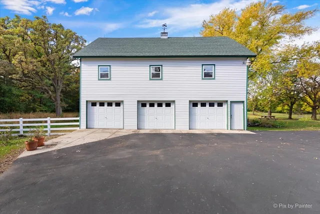 a view of a house with a yard and garage