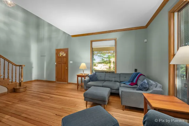 a living room with furniture rug and a window