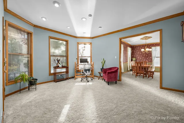 a bedroom with furniture and a large window