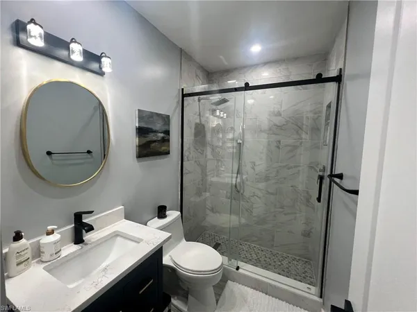 a bathroom with a sink toilet and shower