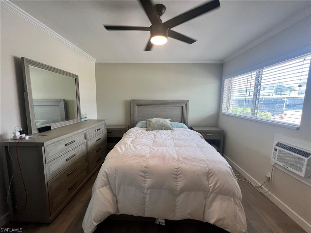 473 12th Avenue South, Unit B6 Naples, FL 34102 - Photo 4 of 10 a bedroom with a large bed and a flat tv screen on dresser