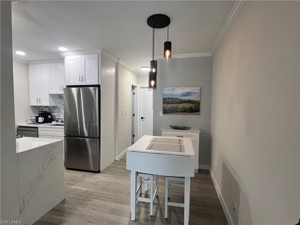 473 12th Avenue South, Unit B6 Naples, FL 34102 - Photo 8 of 10 a kitchen with refrigerator and microwave