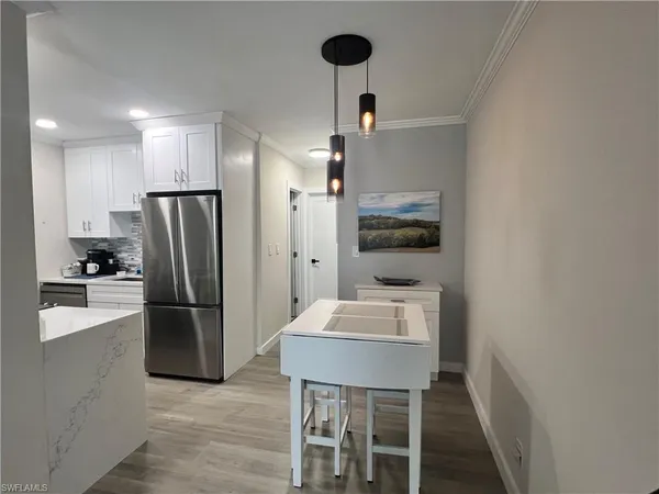 a kitchen with refrigerator and microwave